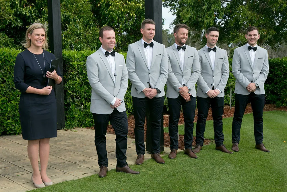 Celebrant standing with the groom and groomsmen